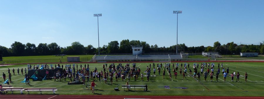 The marching band practices for the halftime show.
