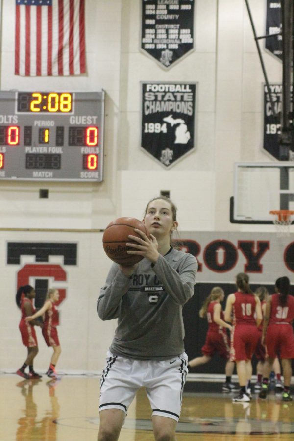 Senior Megan Lenihan shoots the ball before a basketball game.