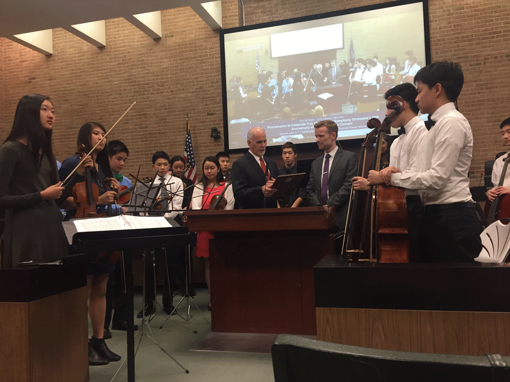 Seniors Allison Feng and Shannon Lin (left) play with the Symphony Orchestra at a city council meeting on Monday, March 6.