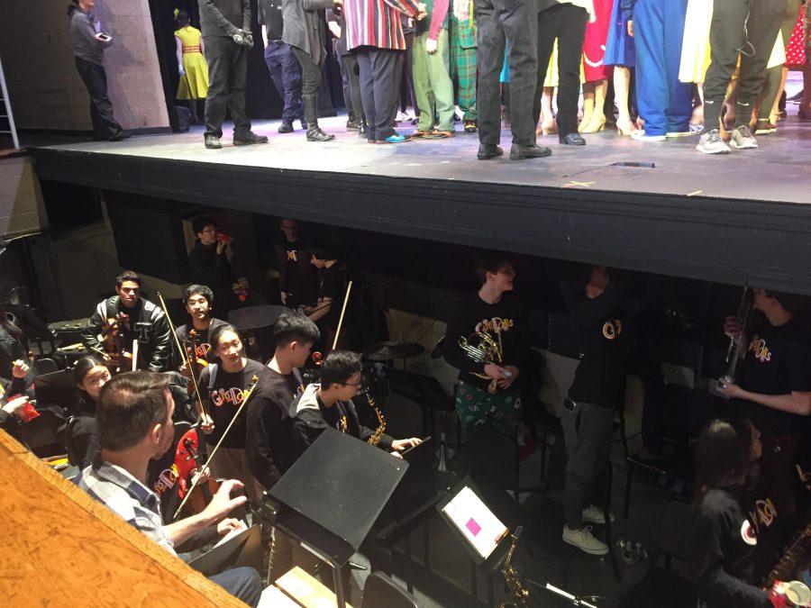 Members of the pit orchestra pack up after the in-school performance of “Guys and Dolls.”