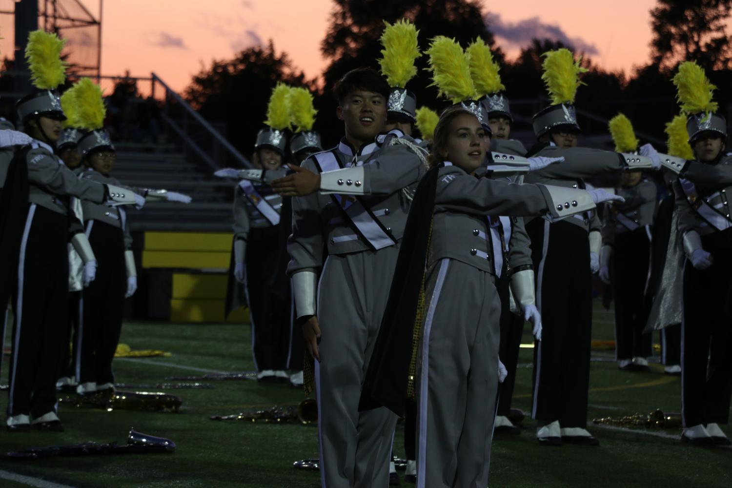 Joining the marching band on the field, Drum Majors, seniors Natalie Fisher and Richard Yan dance with each other.