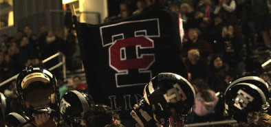 The Troy Colts Football Team celebrates their win over Athens in a huddle.