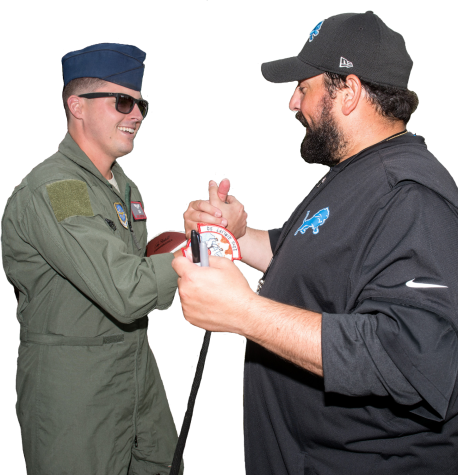 Lions coach Matt Patricia shakes hands with active duty soldier.