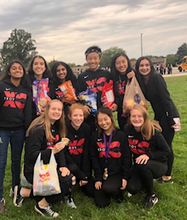 Students on the Cross country team get ready to walk down Northfield Parkway and throw candy. 