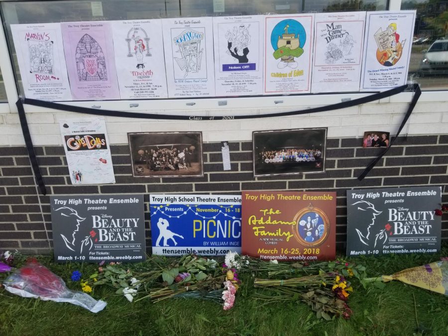 Posters of previous shows and flowers lay in front of the entrance to the auditorm in memory of Rick Bodick.