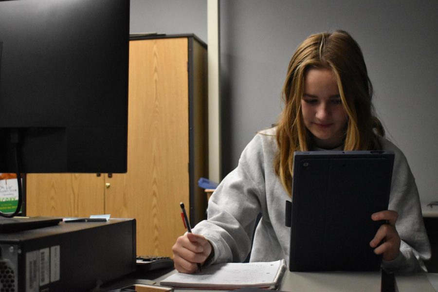 Freshman Ella Koweck works on her iPad given to her by the school.