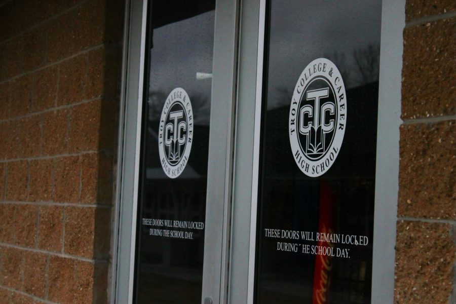 TCCHS is a school with one hallway. The doors bear the logo of the school.