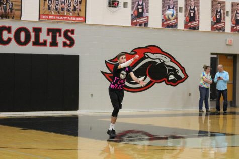 Senior Corey Pichel sets ball during a game against opposing team.