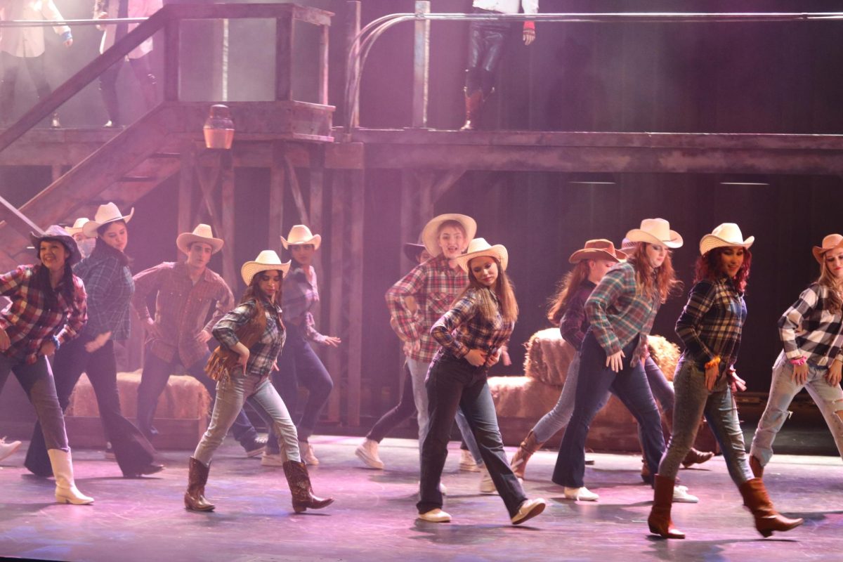The cast of Footloose during a dance number.